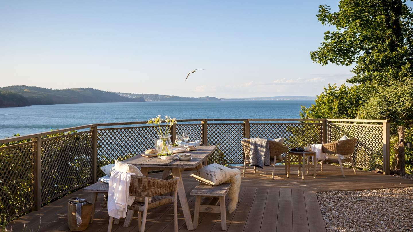 The dining area is a stunning spot to unwind with champagne in hand