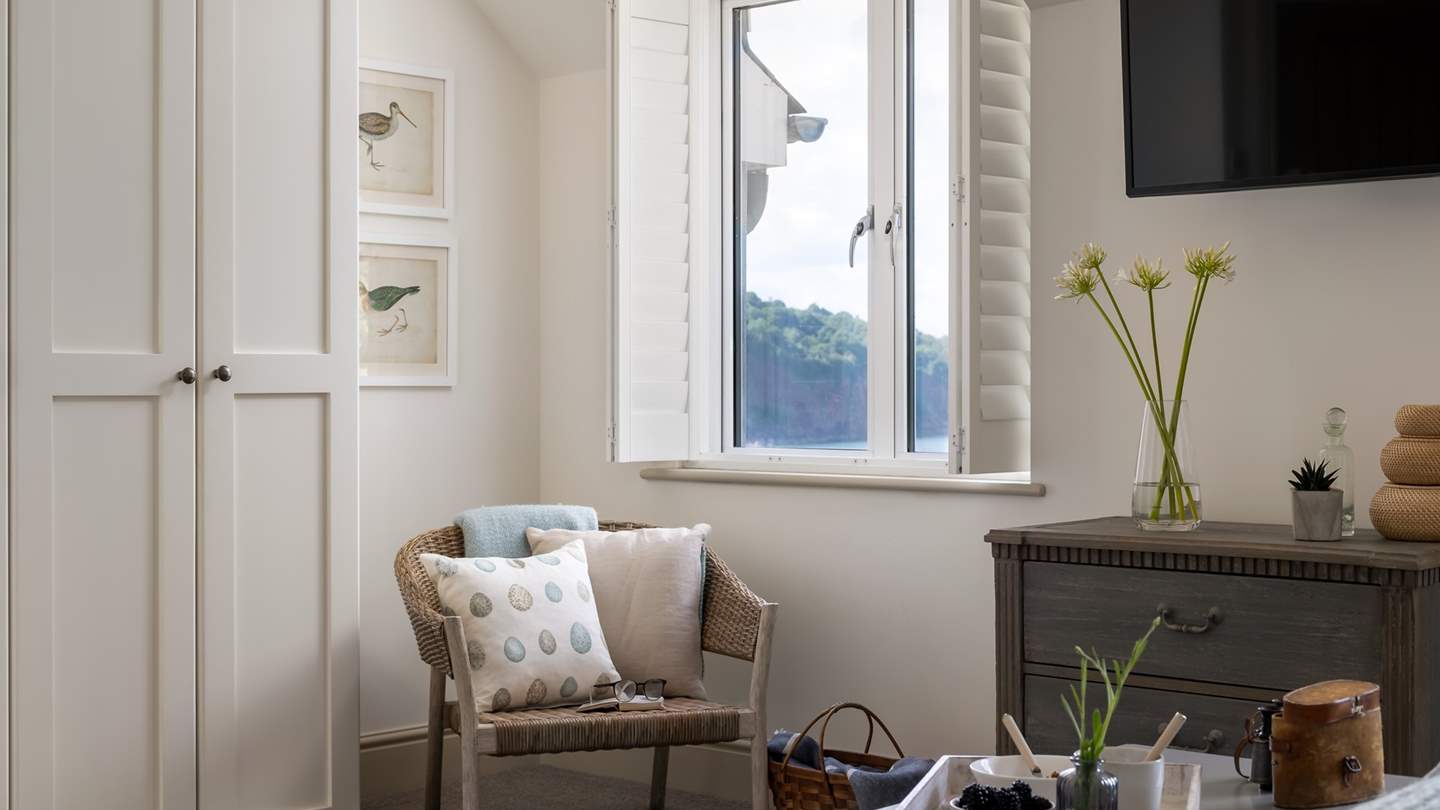 You'll find plenty of space for stowing your belongings in this soothing bedroom