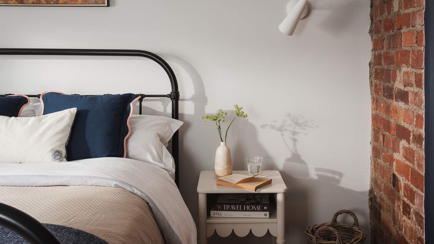 A king-size bed beckons for uninterrupted slumbers beside garden vistas