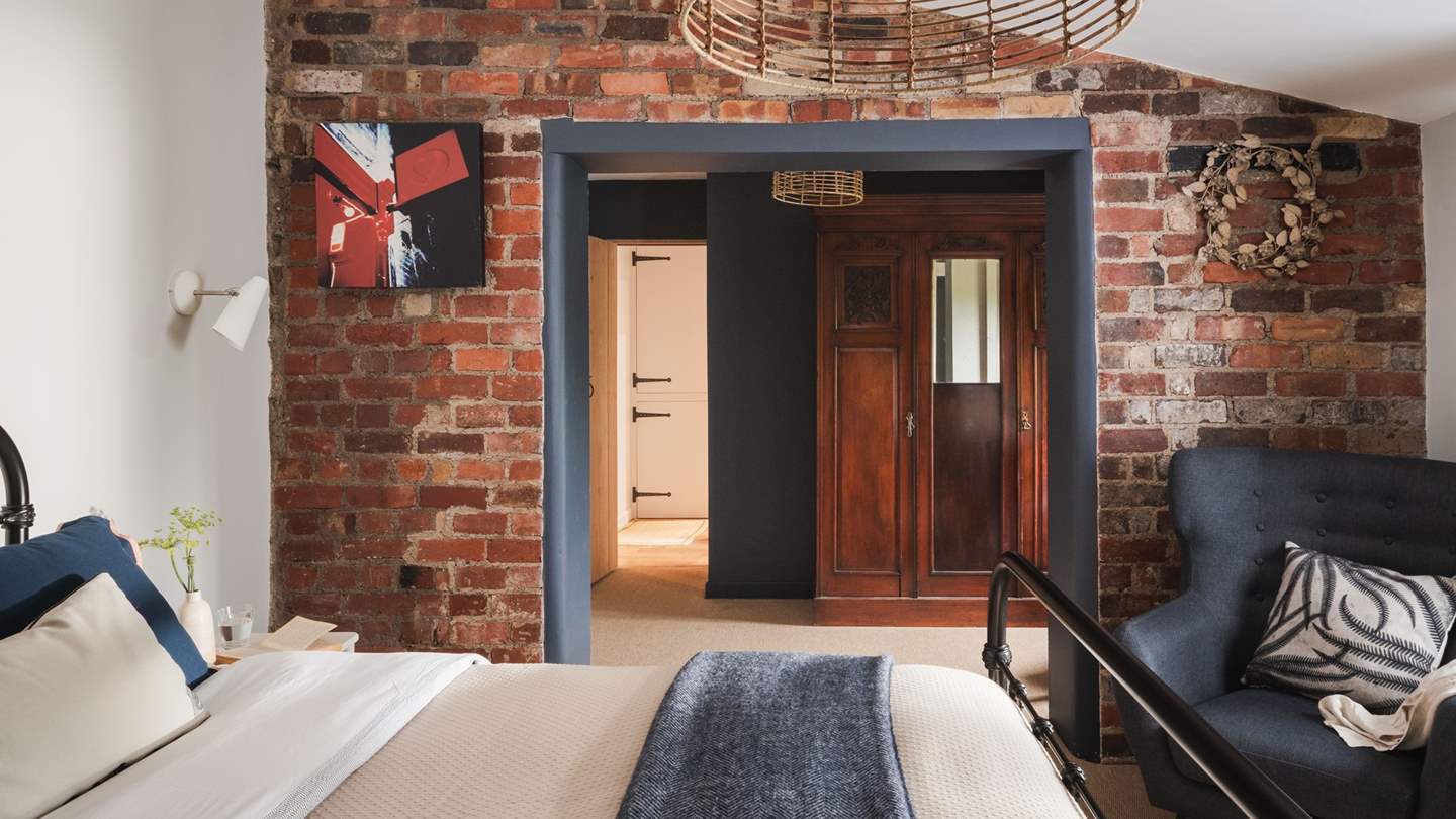 We just adore the beautiful red-brick feature wall and elegant antique pieces throughout