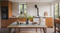 Evoking a retro feel, the kitchen and dining space promises a classic mid-century aesthetic