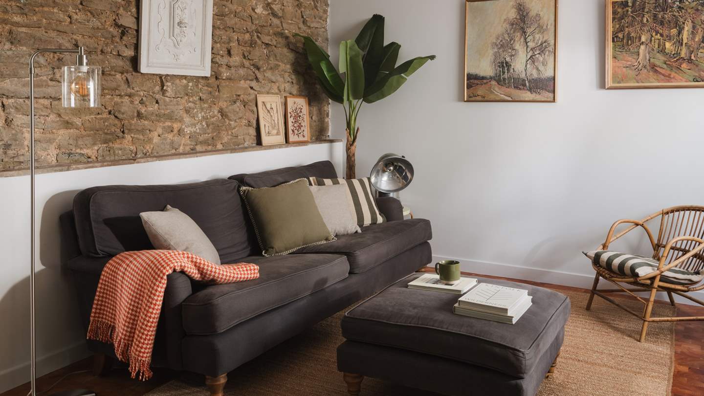 Stretch out in style on the plump, charcoal Loaf sofa with matching footstool
