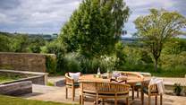 The delightful lawned garden promises far-reaching views of the surrounding Cotswolds countryside