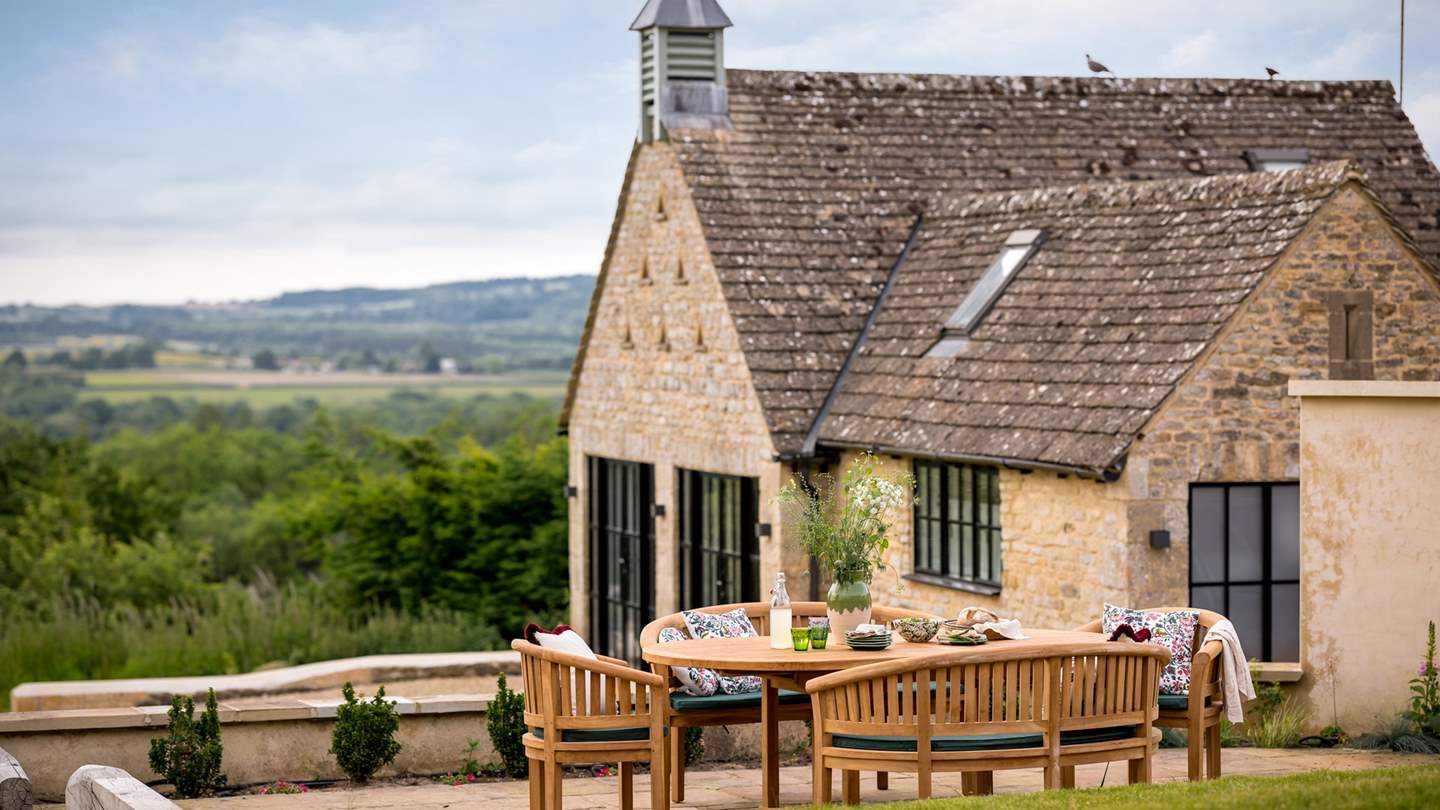 A world of charm resides outdoors in the large garden with a patio