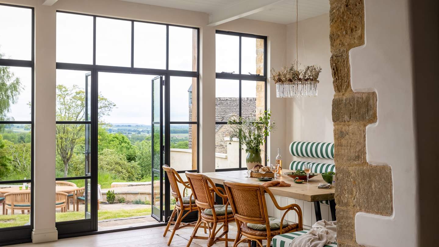 Set beside a subtle lime-washed feature wall is the dining space