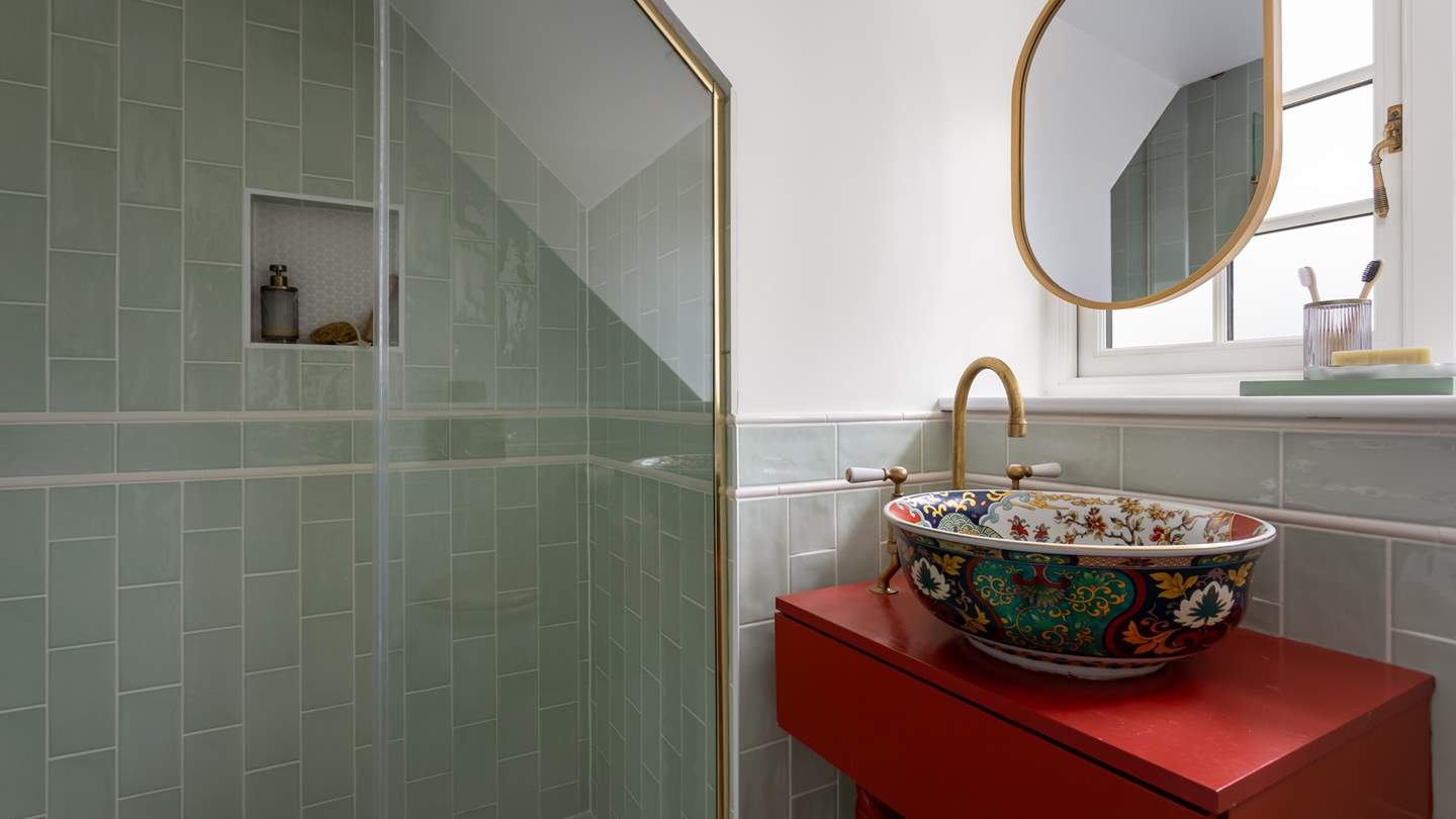 Between bedrooms two and three is a shared family bathroom, where you’ll find a walk-in shower and a Handmade Evelyn chinois wash basin