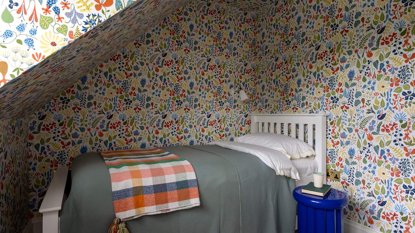 A single bedroom lies next door, promising a vibrant hideout for the little ones