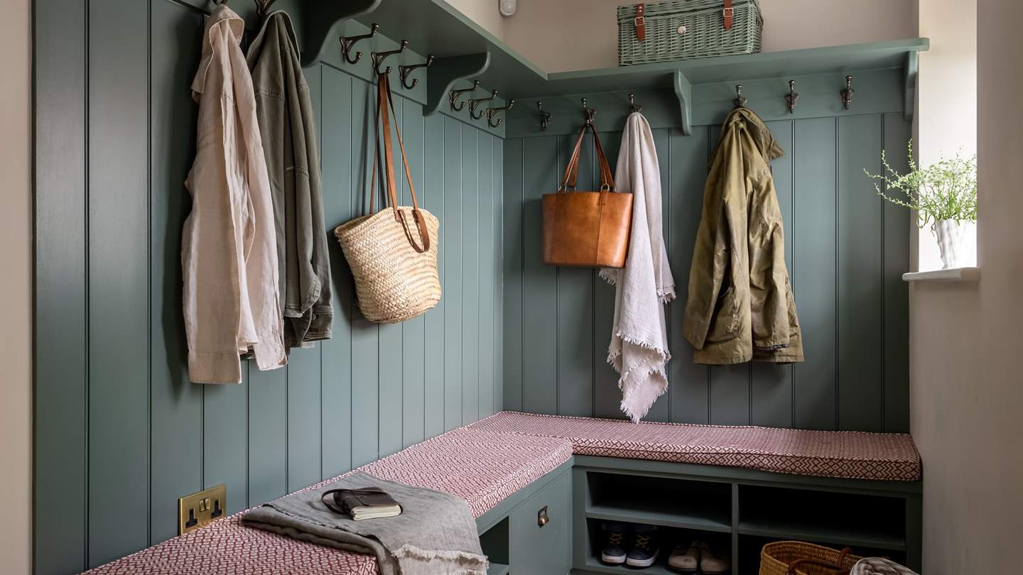 Towards the rear of the retreat is the spacious boot room, with bespoke carpentry storage for coats and jackets