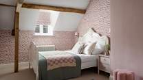 Blush pink tones reign in the fourth bedroom