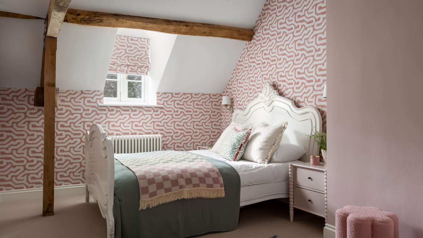Blush pink tones reign in the fourth bedroom