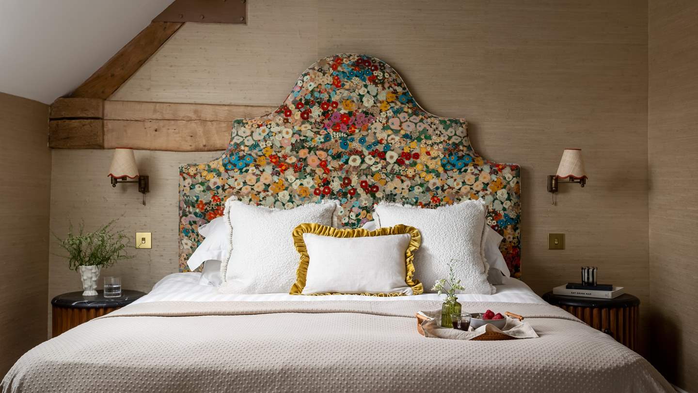 Uncover the sophisticated master bedroom, where rustic beams, scalloped interior finishes and exposed Cotswold stone sets the scene for heavenly slumbers