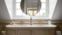 Adding further elegance is the double wash basin topped with marble sinks 