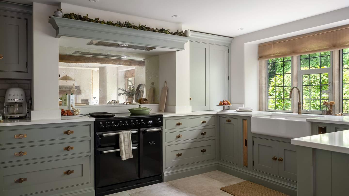 Farmhouse-style units are topped with sleek quartz countertops and brass accents