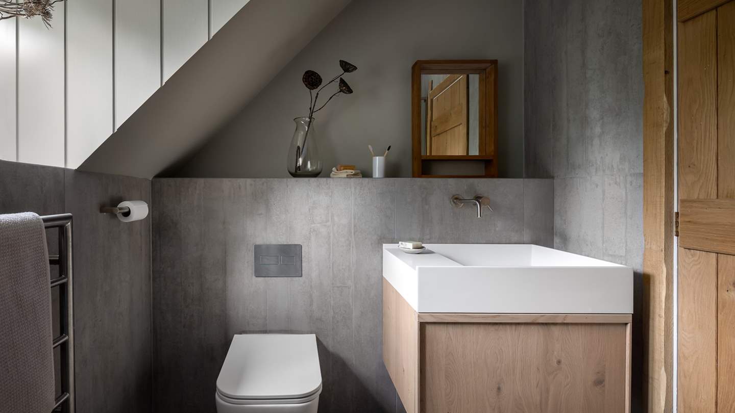 Adjacent is the ensuite bathroom with slate grey tiling