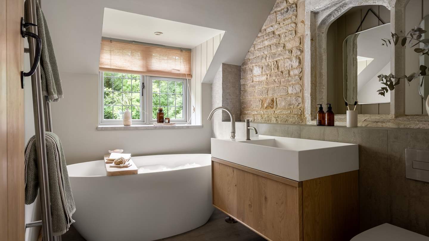 Slip softly into bubble-topped soaks in the rustic family bathroom...