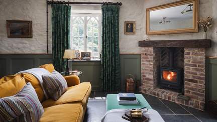 Paired with a teal footstool for those cosy evenings spent fireside