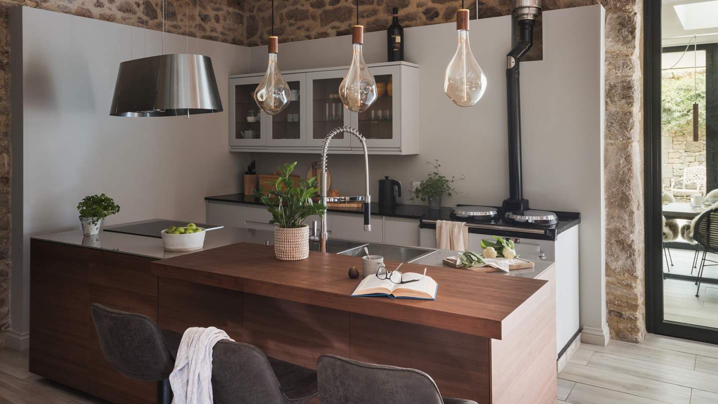 Perfect for gathering throughout the day, three comfortable bar stools hug the kitchen island and tempt for relaxed moments