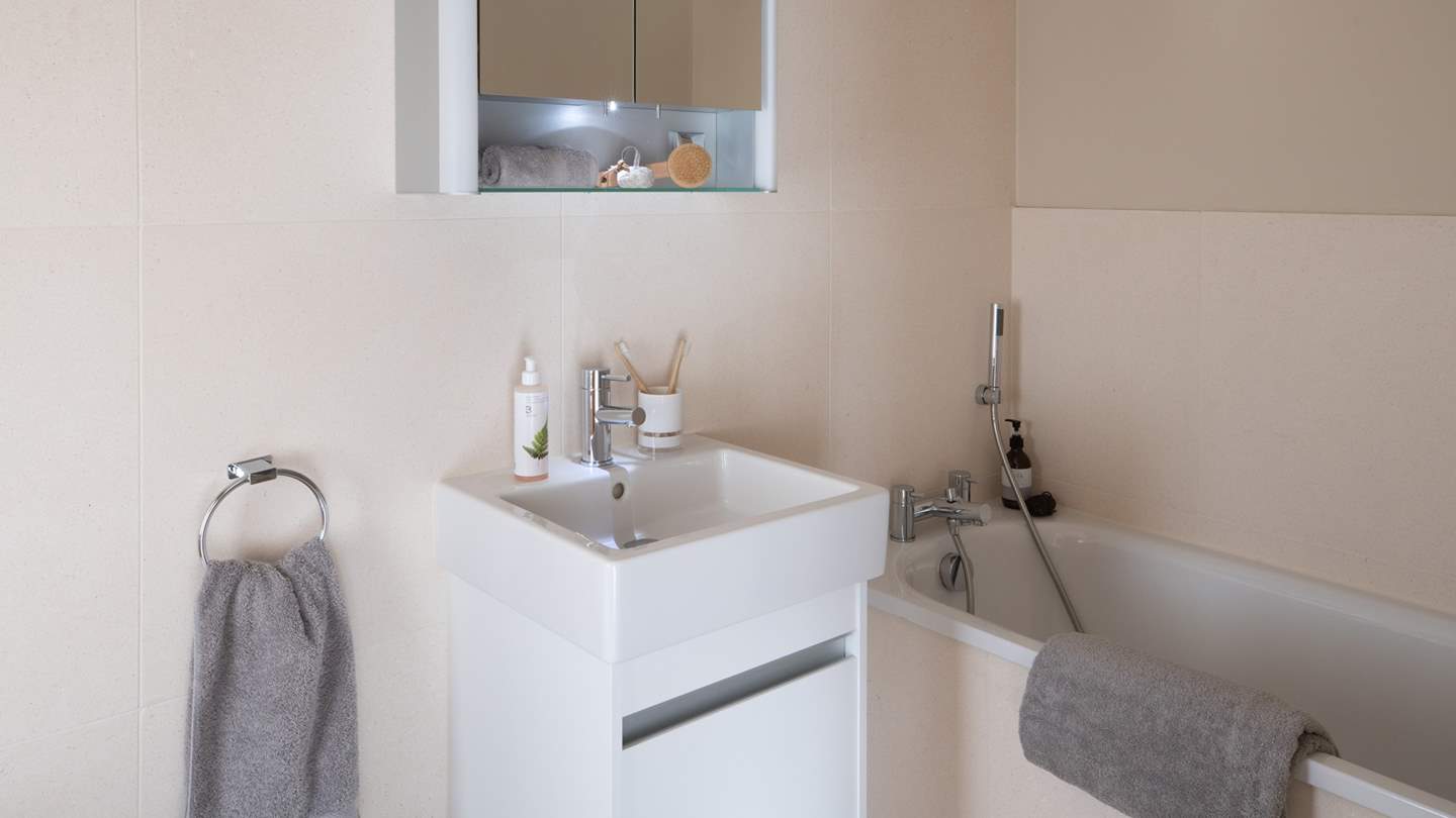 The private ensuite is home to a bath with a separate shower head for bubble-topped soaks