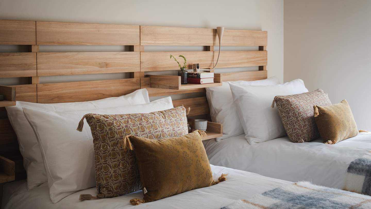 Dressed in stylish shades of gold and grey, this room features two single beds that can be arranged as a super king