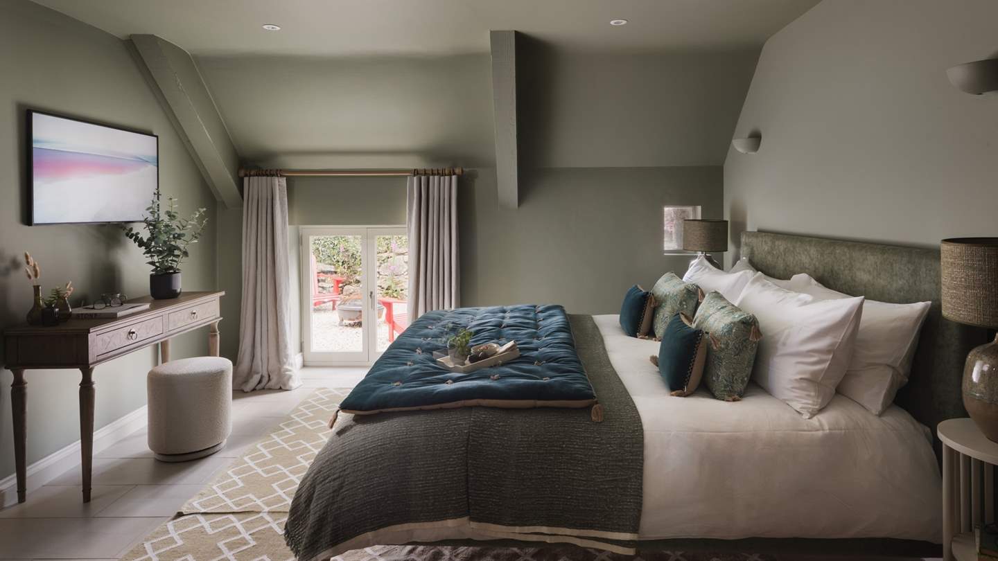 In the centre, a super-king bed topped with the finest linens, cushions and throws beckons for restful repose