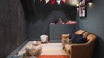 Perfect for little ones, a dedicated playroom with a child-sized sofa, bean bag chair, books and games invites, plus one entire wall is a chalkboard for the artistically minded