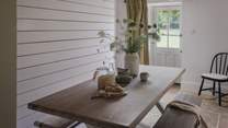 Rustic dining scenes await in the soothing dining space, settled at the cottage entrance 