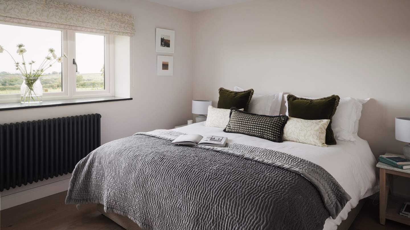 Beckoning for rest and relaxation, the third bedroom, also on the ground floor, offers picturesque countryside views