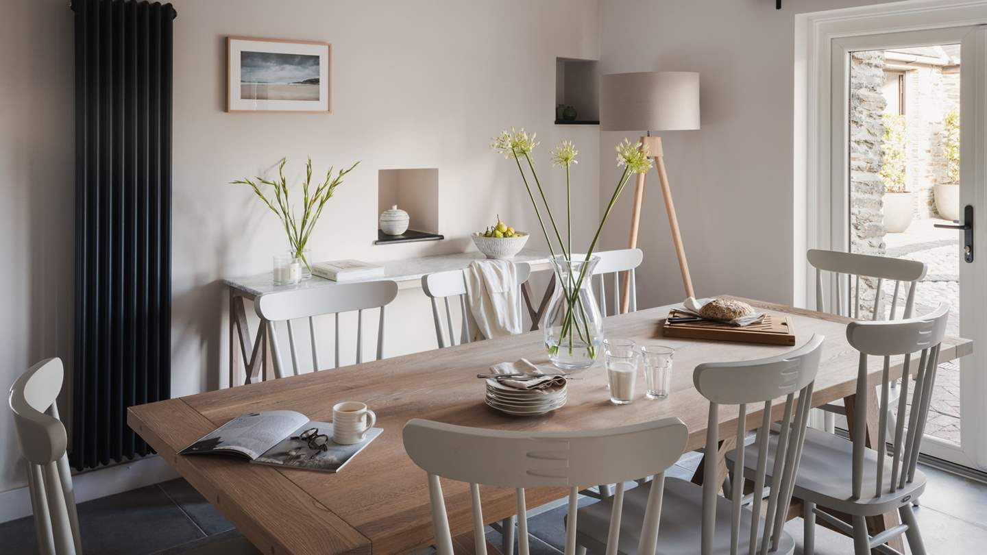 For low-lit dining and celebratory dinners, a large Neptune farmhouse dining table and eight chairs offer room for everyone