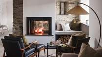The spacious lounge has a double-sided slate wood burning stove positioned in between the sitting and dining rooms