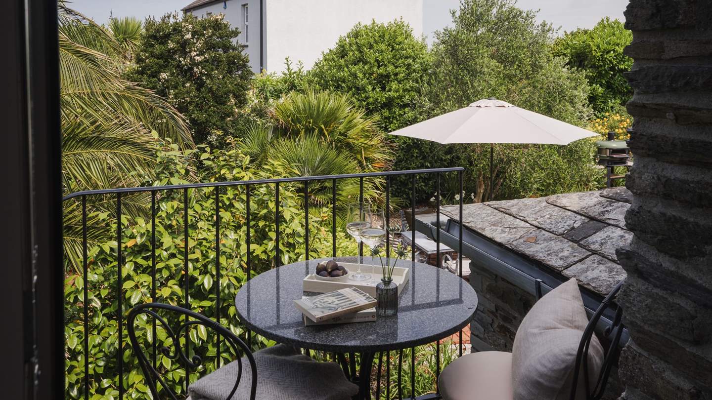 A bistro table and chairs for two just outside, where you can savour morning lattes or savour sunset moments with a glass of wine