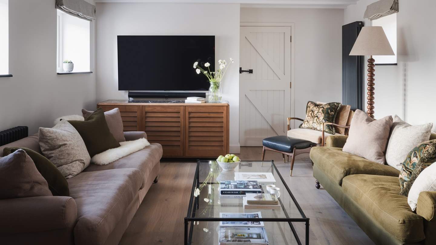 Home to two large sofas, along with two fire side chairs in a cosy corner, a window seat and two other elegant armchairs providing plenty of room for everyone to come together 