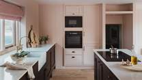 Pretty in blush tones, the charming kitchen sets a beautiful scene for dream feasts together