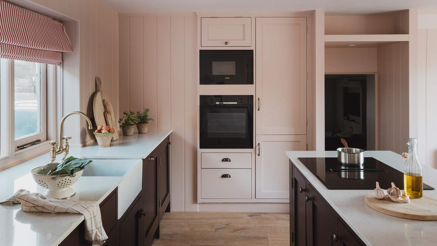 Pretty in blush tones, the charming kitchen sets a beautiful scene for dream feasts together