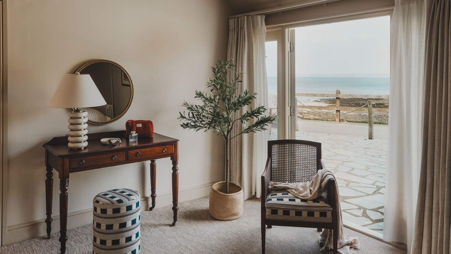 An additional space is framed by patio doors that open to the sea-view terrace