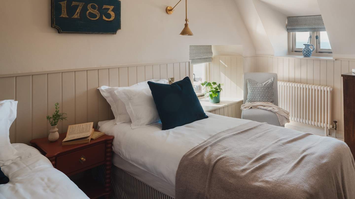 Windows open to bay views, while an armchair offers somewhere to simply watch the world go by