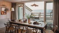 Gather around the main dining table with seating for up to eight and equally mesmeric sea views