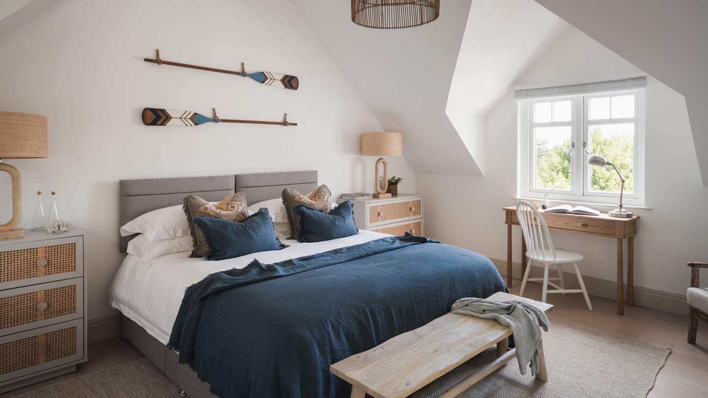 The third bedroom is a picture of perfection with characterful ceilings and an alcove window offering views over the ocean beyond