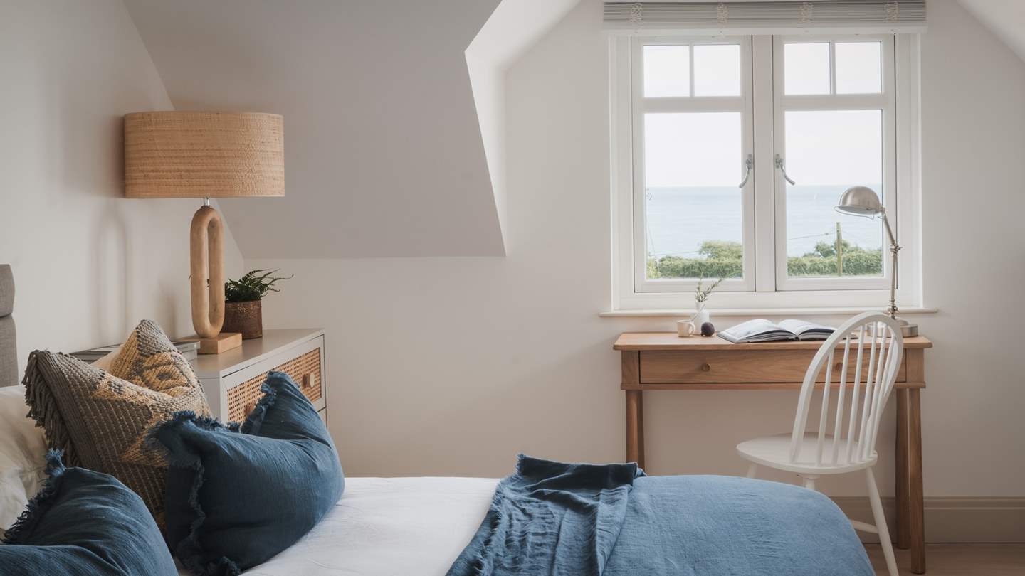 For moments of creative expression, a writing desk and chair sit in front of the sea-view window