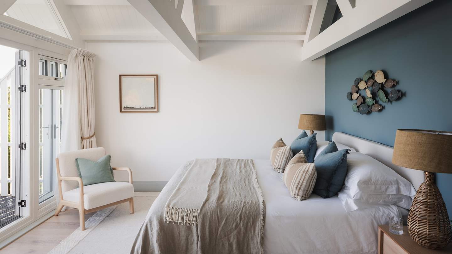 Situated on the first floor, the master bedroom is carefully curated with a calming colour palette and a statement wall