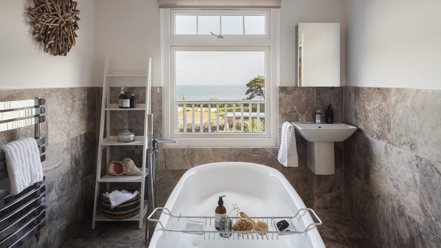 Completing the picture is an exquisite ensuite bathroom with brown marble tiles and both a shower and freestanding bath