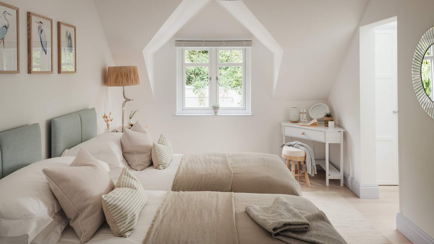 An alcove window shares picturesque views over the garden