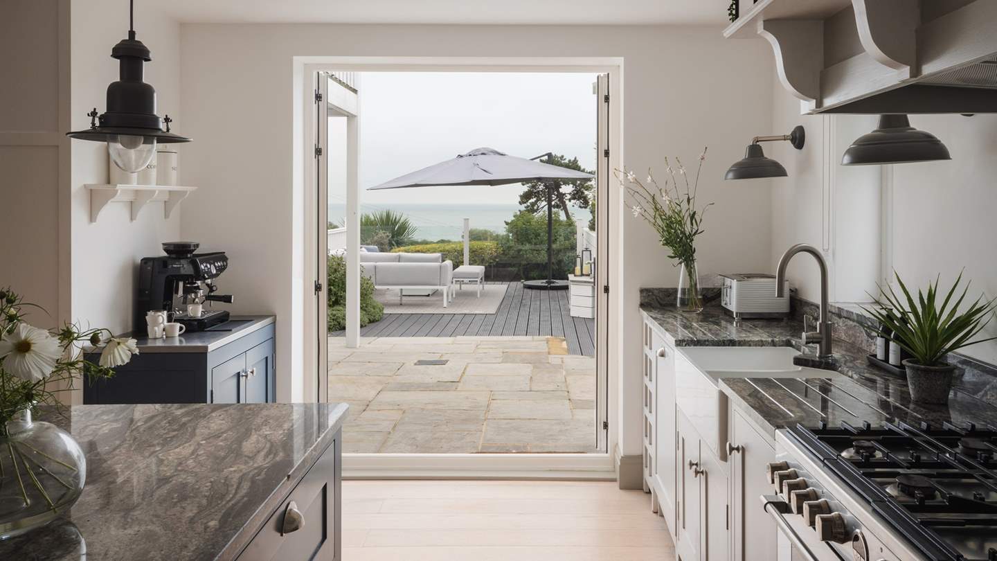 A welcome balmy sea breeze during the warmer months through the glass doors opening out onto the garden terrace and dining area