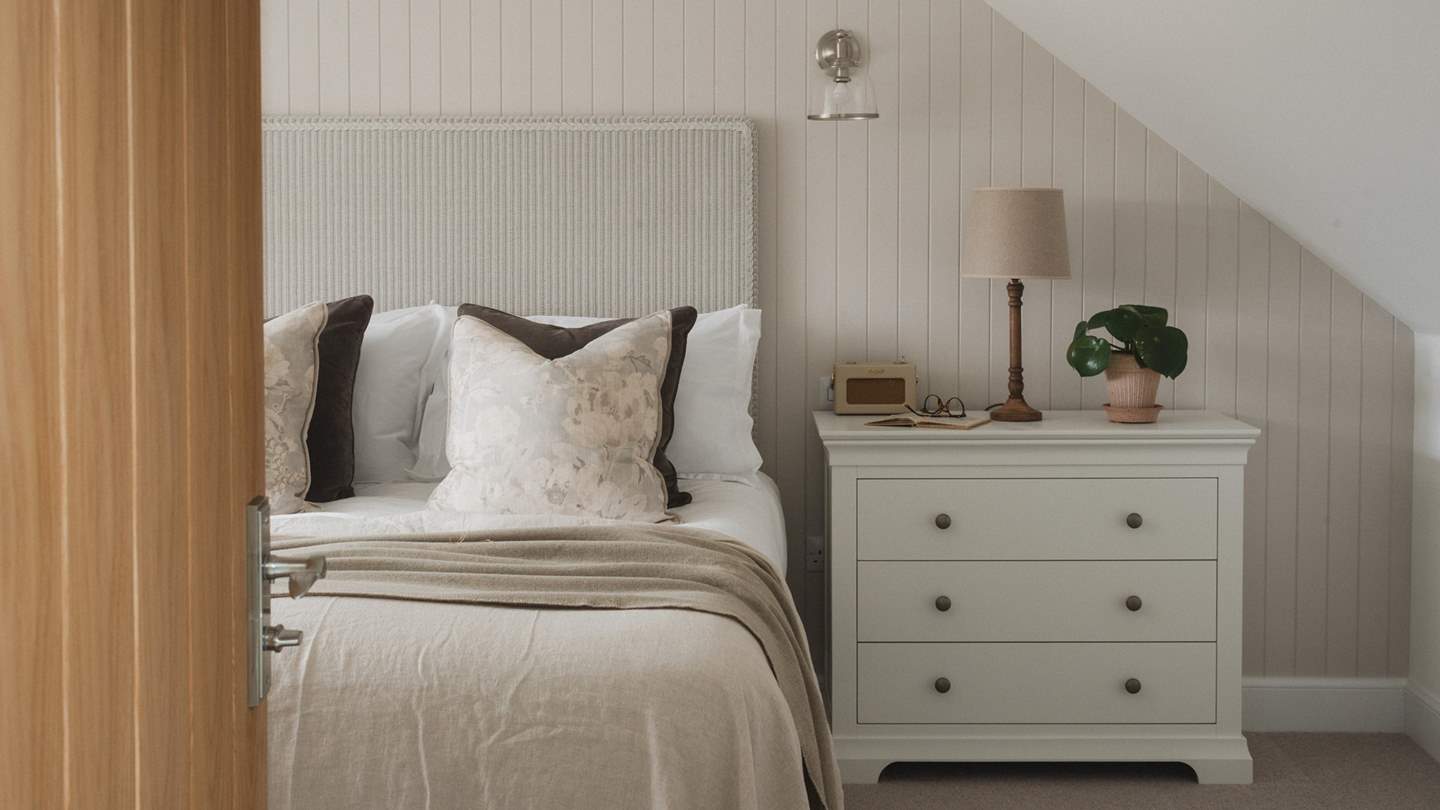 For storing belongings, you’ll find two chests of drawers, with the additional hanging space