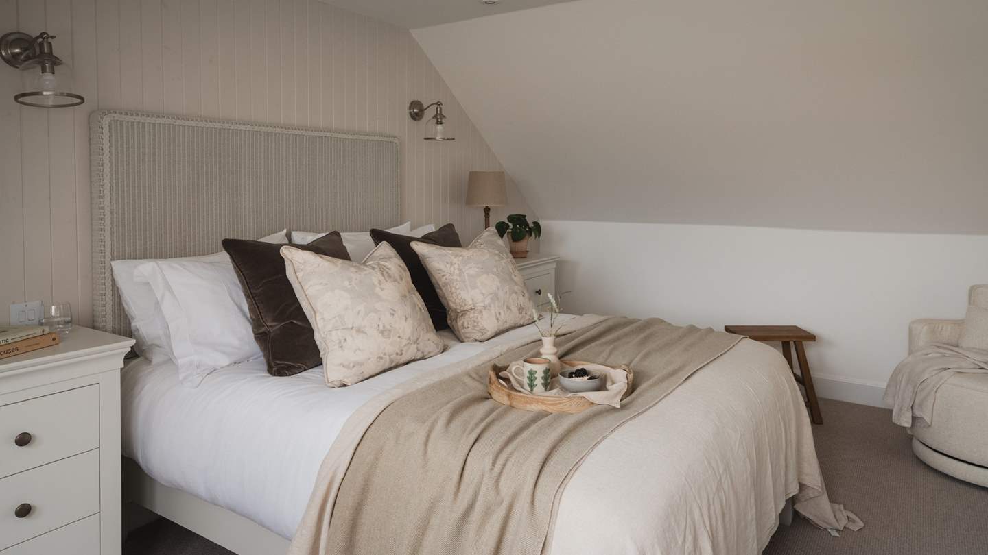 The sweetest of dreams await beneath the finest linens in the master bedroom