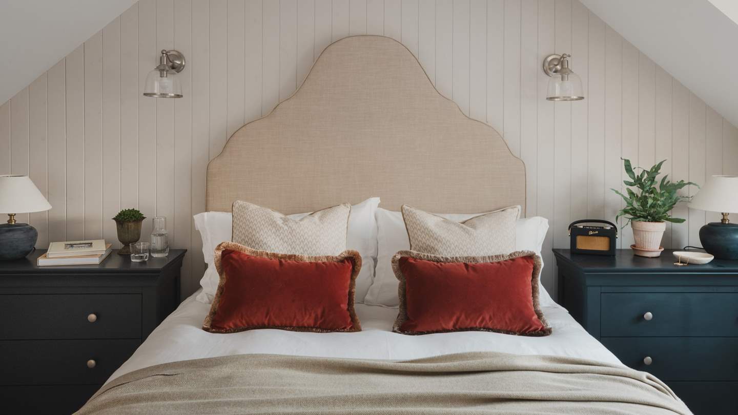 Contemporary glass wall lights are a chic addition for those looking to read from the comfort of cosy linens