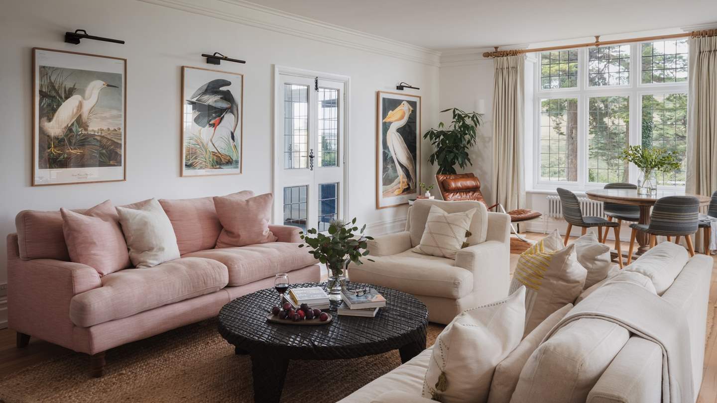 A collection of two sumptuous sofas and an armchair gather around a crosscut coffee table