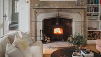 Gather around the wood burning stove, set within a striking granite fireplace 
