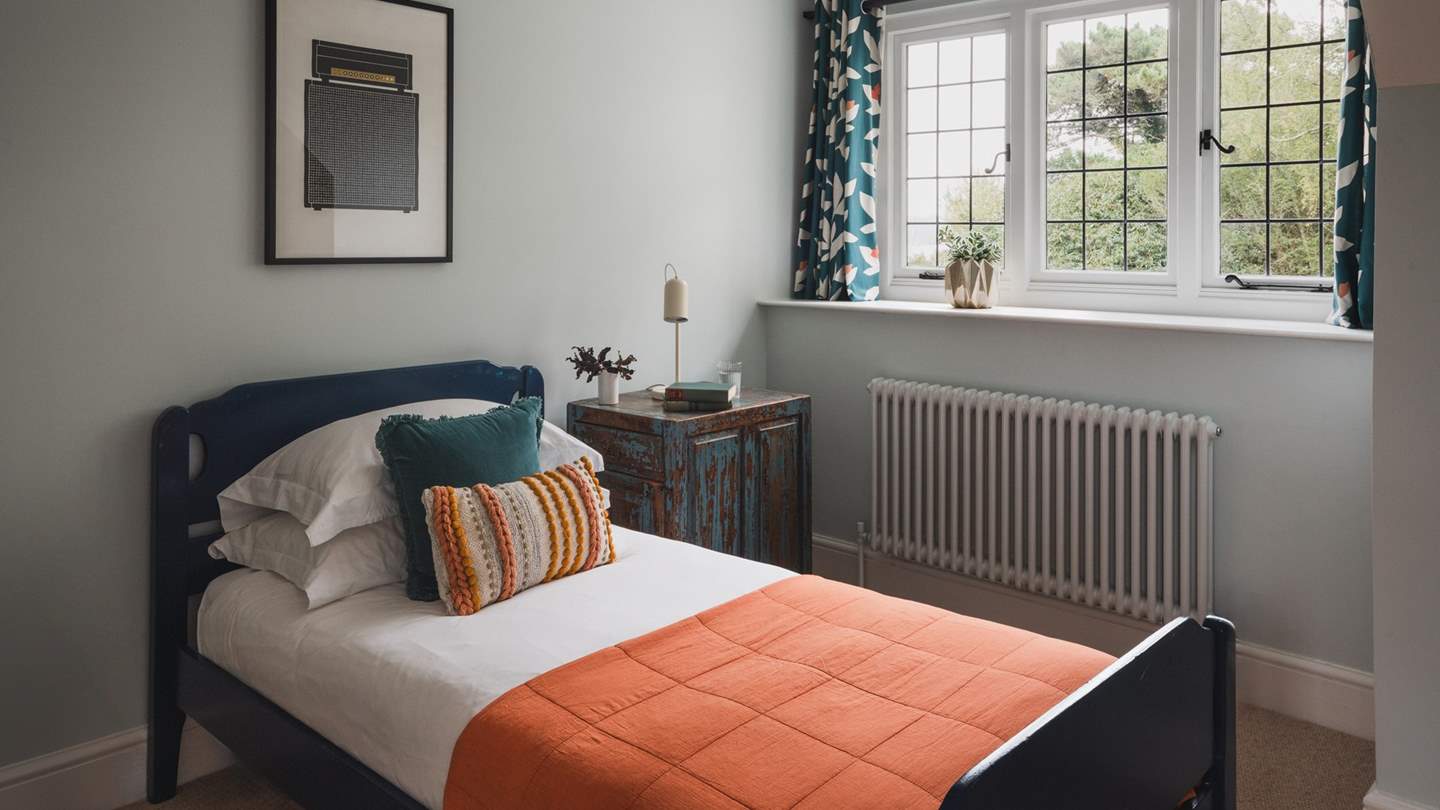 Calling for sweet slumbers, the fourth bedroom is home to a single bed dressed in the highest quality linens