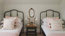 Two single beds can be found in the pretty fifth bedroom