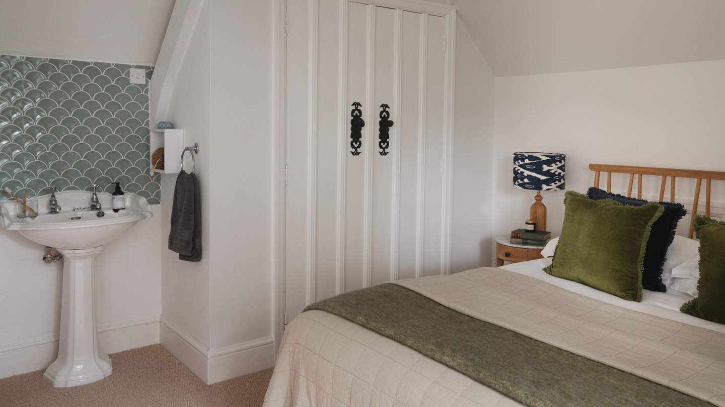 Decorated in earthy tones, the sixth bedroom has a king size bed draped in cloud-soft linens 